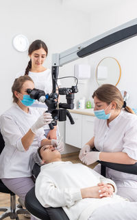 Female doctor examining patient at clinic