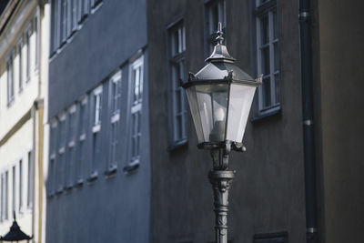 Low angle view of street light against building