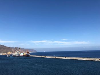 Scenic view of sea against blue sky