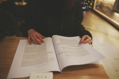 Man writing on book