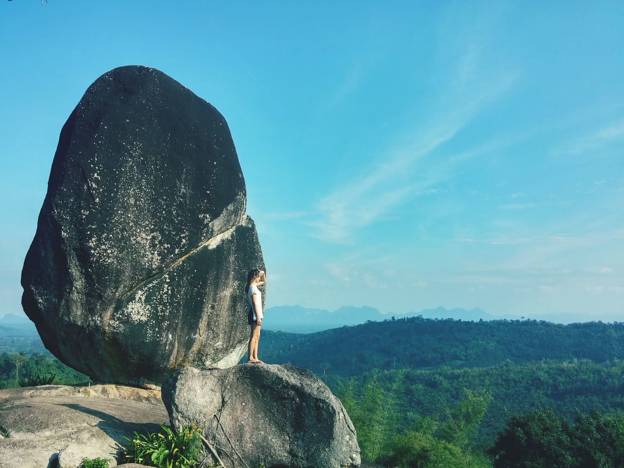 sky, tranquility, rock - object, landscape, tranquil scene, nature, scenics, beauty in nature, blue, one person, sunlight, day, one animal, rock formation, grass, outdoors, rock, clear sky, non-urban scene, tree