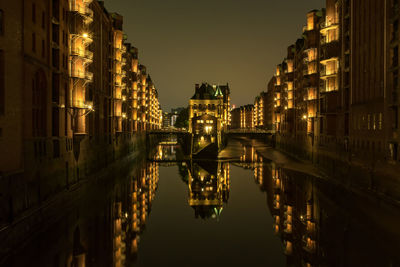 Reflection of illuminated buildings in canal at night