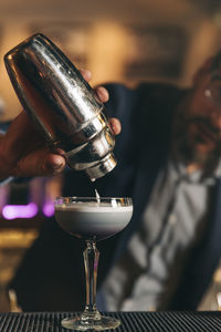 Male bartender preparing cocktail at bar counter