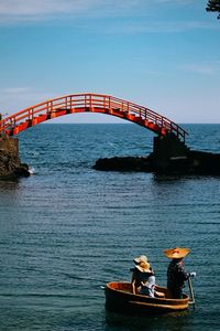 Bridge over sea against sky