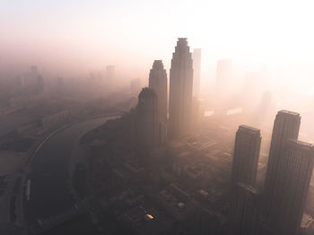 High angle view of buildings in city during sunset