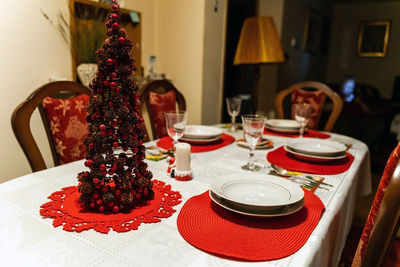 Christmas dinner feast. a decorated dining table with champagne wine glasses and christmas tree