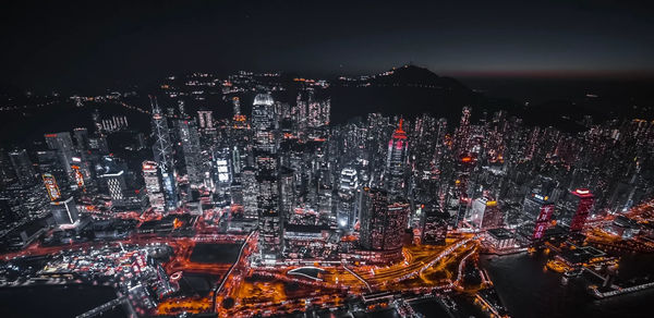 High angle view of city lit up at night