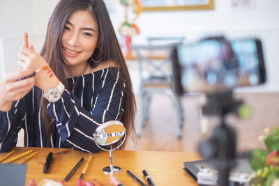 Portrait of a smiling young woman holding ice cream