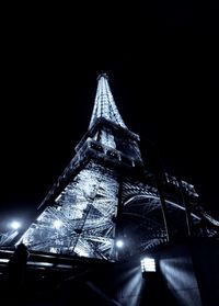 Low angle view of illuminated building against sky at night