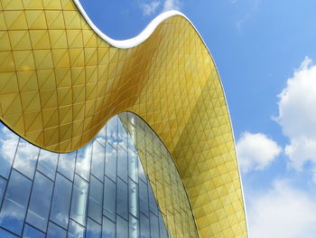 Low angle view of yellow building against sky