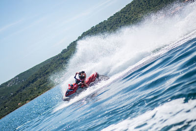 Man riding jet boat on sea