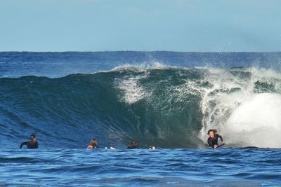 People surfing in sea