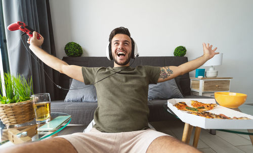 Midsection of man sitting on table