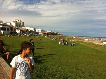 People relaxing on grassy field