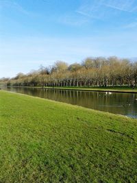 Scenic view of river against cloudy sky