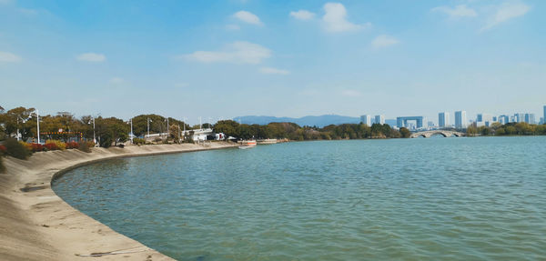 Scenic view of sea by buildings against sky