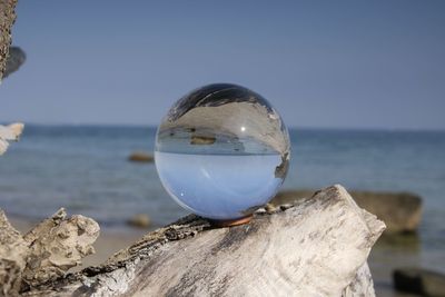 Close-up of crystal ball on rock