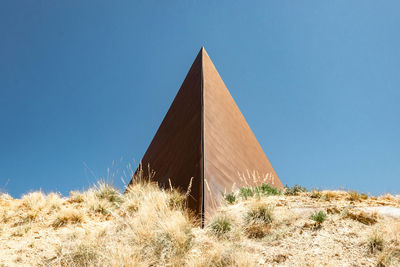 View of desert against clear blue sky