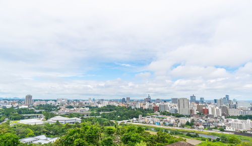 High angle view of buildings in city against sky