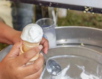 Midsection of woman holding ice cream