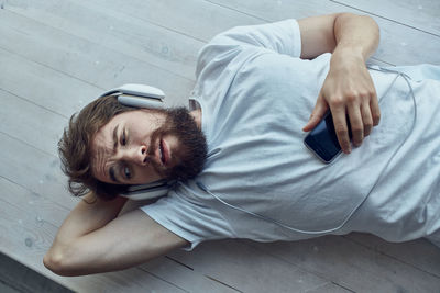 High angle view of man relaxing on floor at home