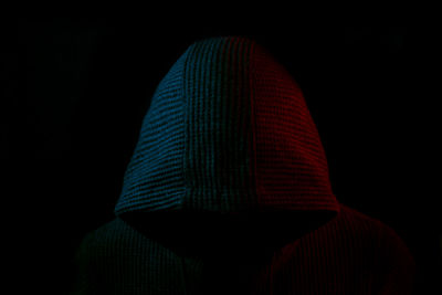 Rear view of person against black background