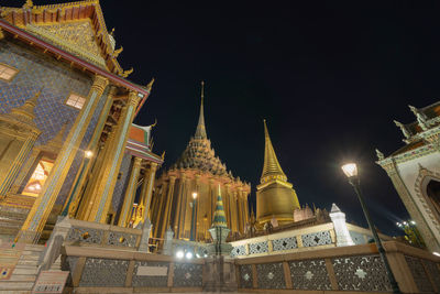 Low angle view of illuminated temple building against sky at night