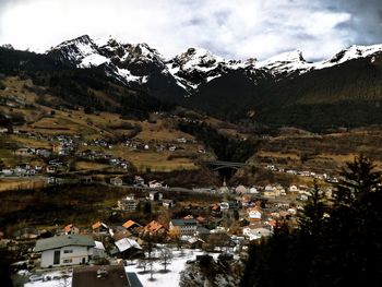 Scenic view of town against cloudy sky