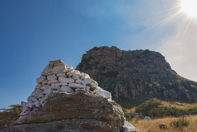 Low angle view of rock formation against sky