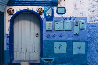 Closed door of old building with handprints