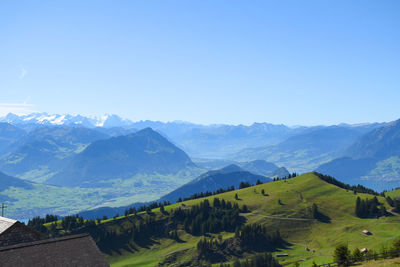 Scenic view of mountains against clear blue sky