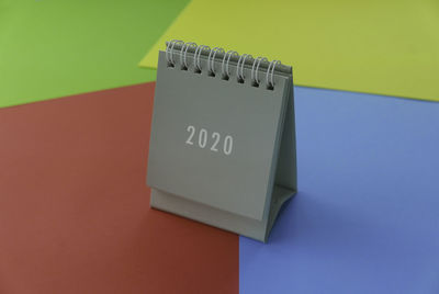 High angle view of information sign on table against wall