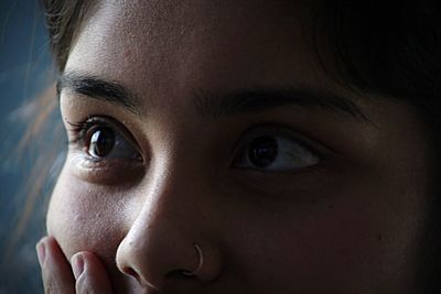 Close-up of thoughtful young woman at home