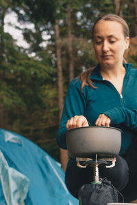 Woman preparing food at camping site