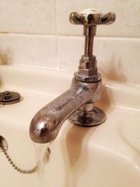 Close-up of faucet in bathroom