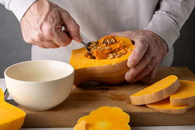 Midsection of man holding pumpkin