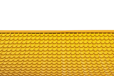 Close-up of yellow wall against white background