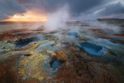 The beautiful colorful mud pools at the geothermal are in gunnuhver in iceland during sunrise. 