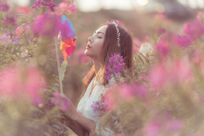 Woman standing on pink flowering plants