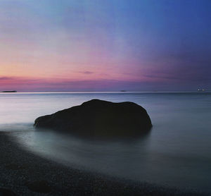 Scenic view of sea against sky at sunset