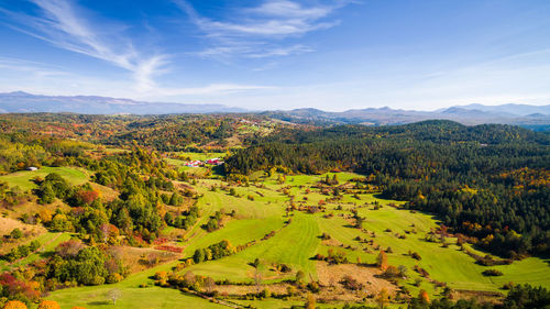 Scenic view of green landscape against sky