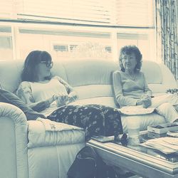 Young woman sitting on sofa at home