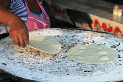 Midsection of female chef preparing food