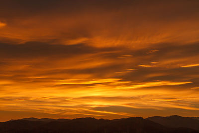 Scenic view of dramatic sky during sunset