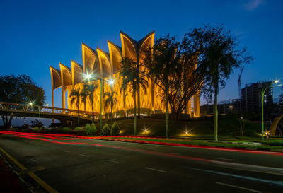 Light trails on road against sky at night