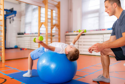 Pectoral or chest muscle exercises for children with a fitness ball