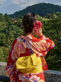 Rear view of woman looking at mountains