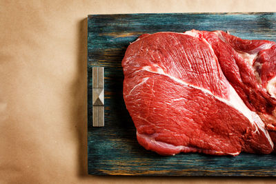 Top view of beef raw meat on wooden tray with copy space, close-up