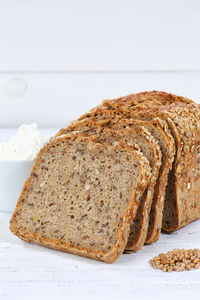 Close-up of bread on table against white background