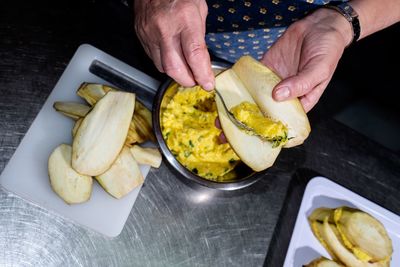 Midsection of man preparing food in kitchen at home